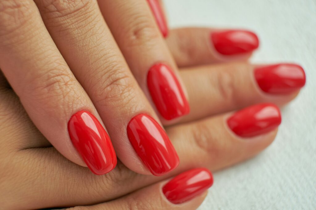 perfect red manicure. nail and hand care in the salon